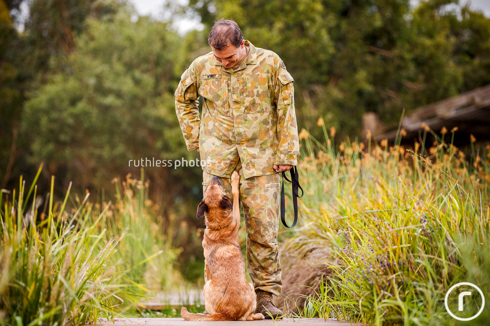 a soldier in fatigues with loyal dog