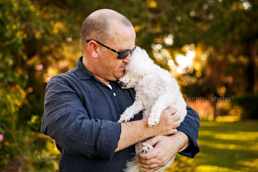 male owner hugging senior dog